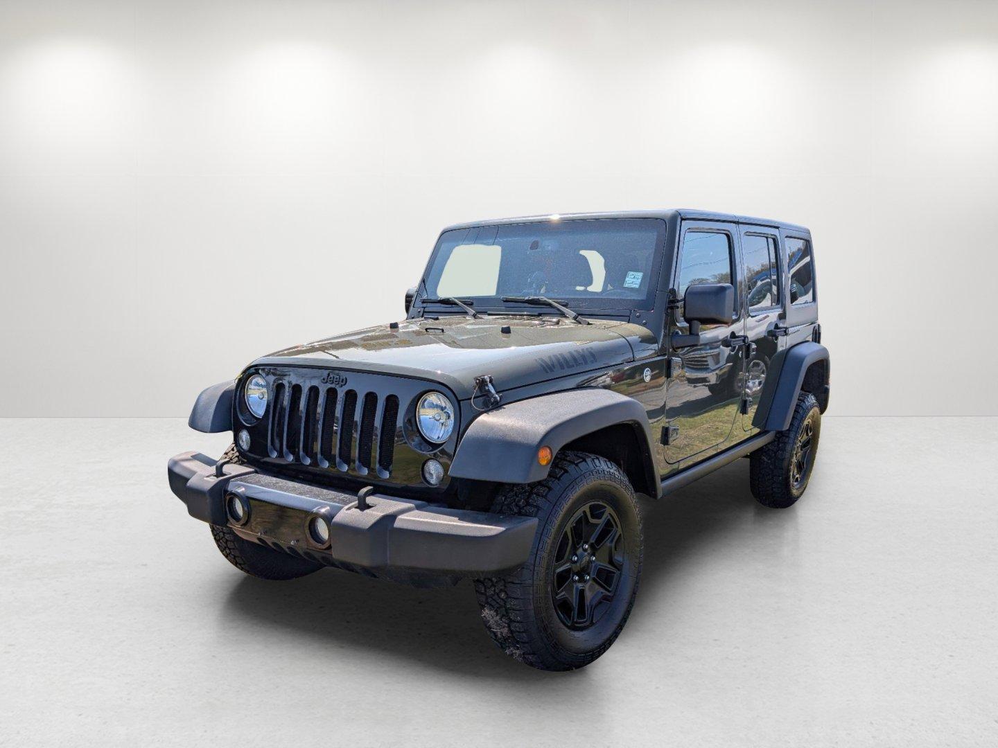 2016 /Black Jeep Wrangler Unlimited Willys Wheeler (1C4BJWDG9GL) with an Regular Unleaded V-6 3.6 L/220 engine, 6-Speed Manual w/OD transmission, located at 804 22nd Ave, Phenix City, AL, 36870, (334) 297-1860, 32.484749, -85.024475 - 2016 Jeep Wrangler Unlimited Willys Wheeler - Photo#0