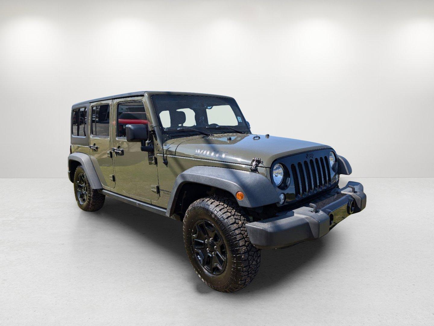 2016 /Black Jeep Wrangler Unlimited Willys Wheeler (1C4BJWDG9GL) with an Regular Unleaded V-6 3.6 L/220 engine, 6-Speed Manual w/OD transmission, located at 804 22nd Ave, Phenix City, AL, 36870, (334) 297-1860, 32.484749, -85.024475 - 2016 Jeep Wrangler Unlimited Willys Wheeler - Photo#2