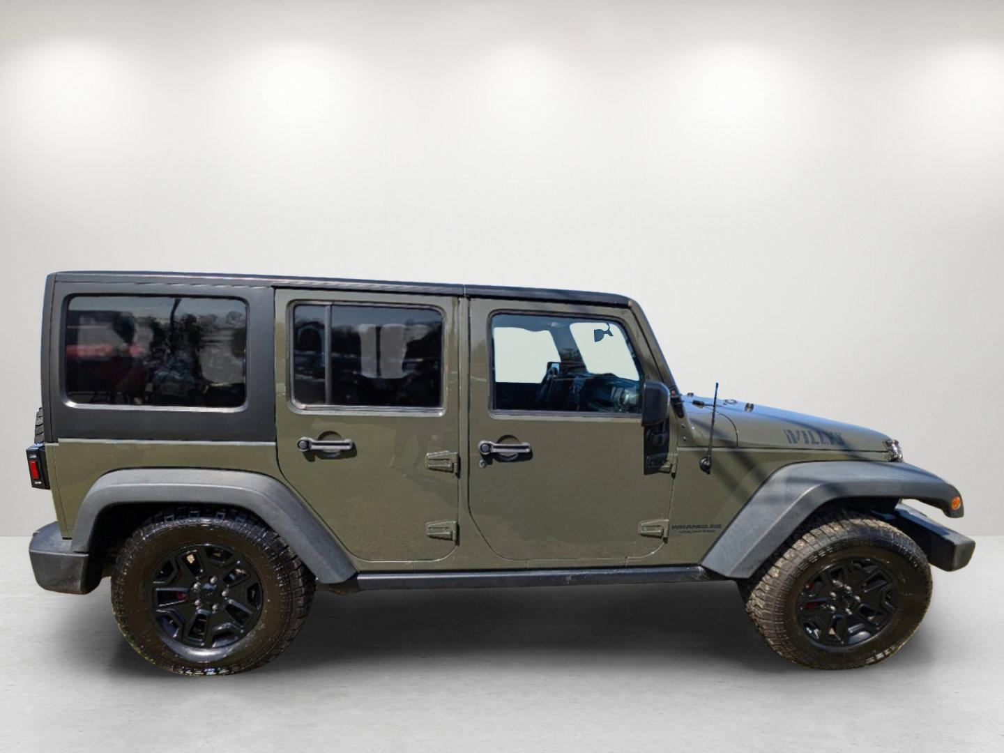 2016 /Black Jeep Wrangler Unlimited Willys Wheeler (1C4BJWDG9GL) with an Regular Unleaded V-6 3.6 L/220 engine, 6-Speed Manual w/OD transmission, located at 804 22nd Ave, Phenix City, AL, 36870, (334) 297-1860, 32.484749, -85.024475 - 2016 Jeep Wrangler Unlimited Willys Wheeler - Photo#3