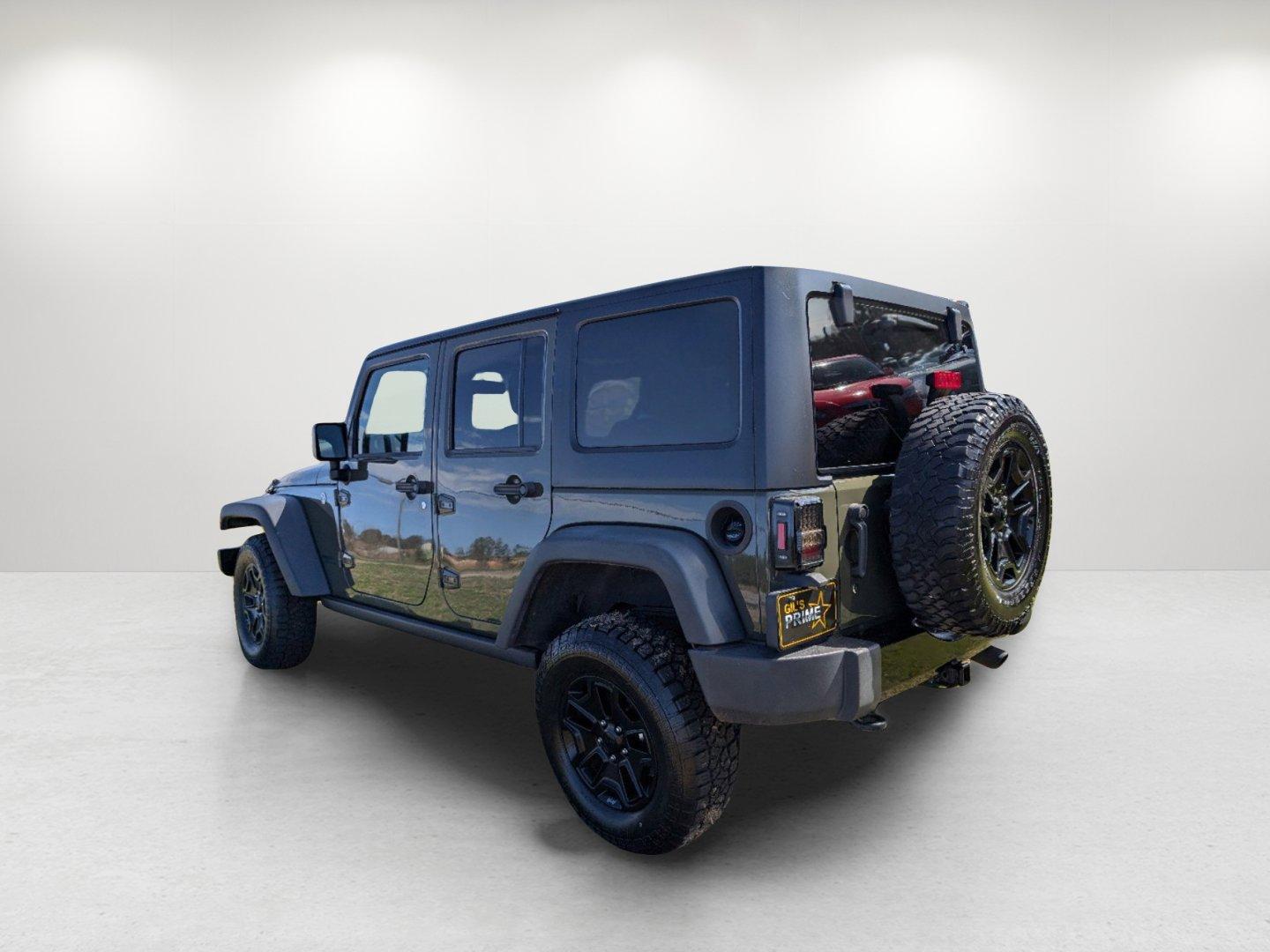 2016 /Black Jeep Wrangler Unlimited Willys Wheeler (1C4BJWDG9GL) with an Regular Unleaded V-6 3.6 L/220 engine, 6-Speed Manual w/OD transmission, located at 804 22nd Ave, Phenix City, AL, 36870, (334) 297-1860, 32.484749, -85.024475 - 2016 Jeep Wrangler Unlimited Willys Wheeler - Photo#6